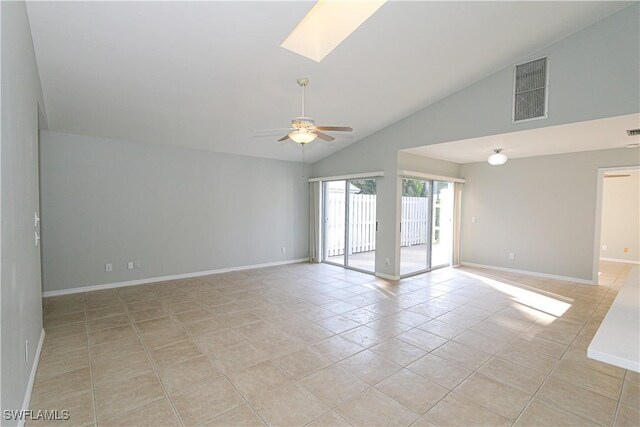 empty room featuring ceiling fan, light tile patterned flooring, a skylight, visible vents, and baseboards