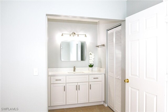 bathroom featuring tile patterned flooring, a closet, and vanity