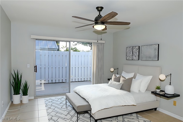 bedroom featuring light tile patterned floors, a ceiling fan, baseboards, and access to outside