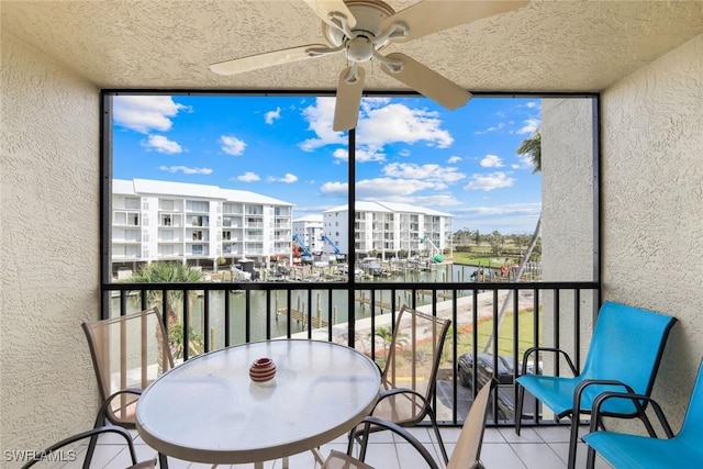 balcony featuring a sunroom and ceiling fan