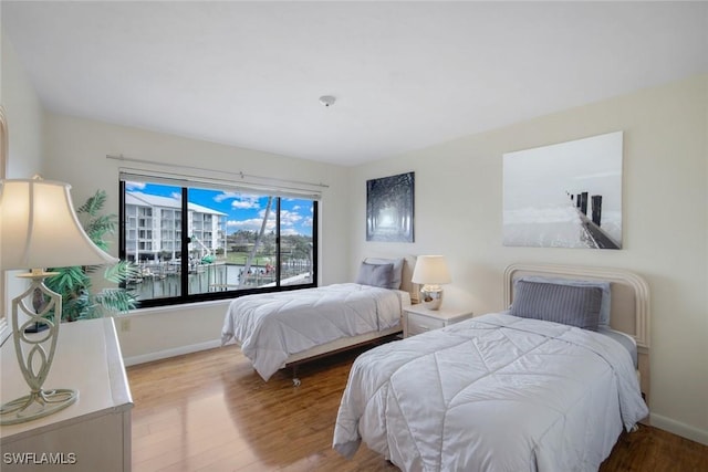 bedroom featuring wood finished floors and baseboards