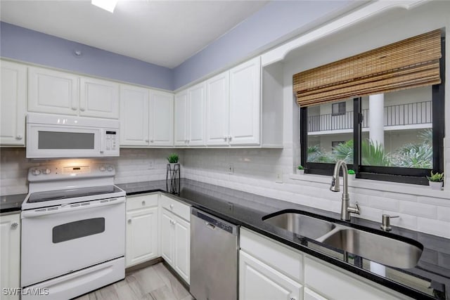 kitchen featuring white appliances, a sink, and decorative backsplash