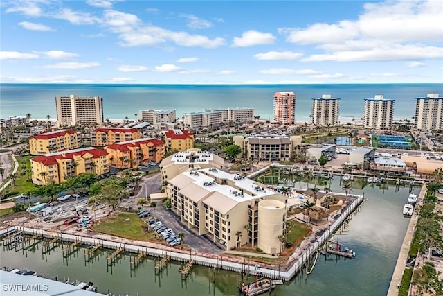 birds eye view of property featuring a water view and a city view