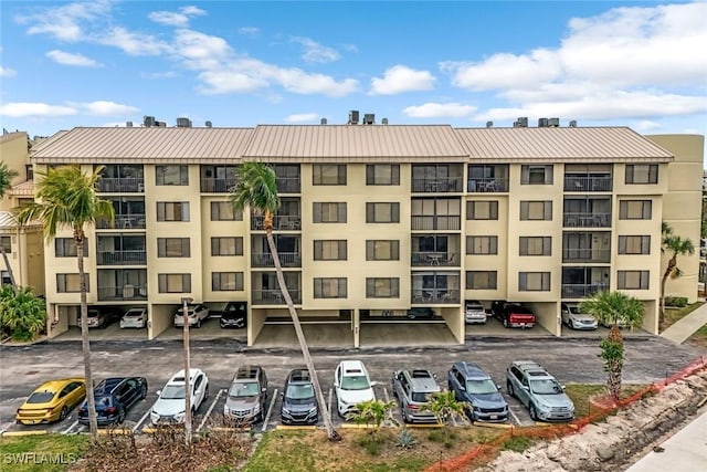 view of building exterior with uncovered parking