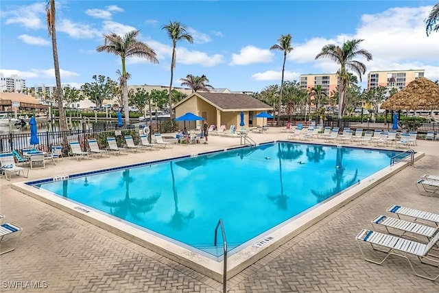 pool featuring a patio area and fence