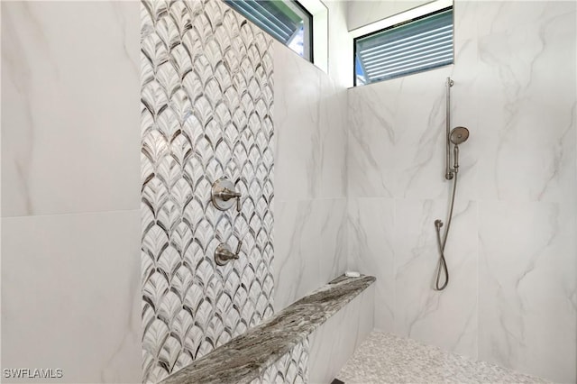 full bath featuring a marble finish shower