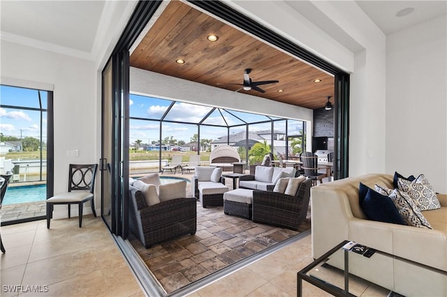 view of patio / terrace featuring ceiling fan, glass enclosure, an outdoor living space, and an outdoor pool