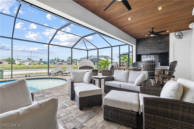 view of patio / terrace featuring an outdoor pool, glass enclosure, an outdoor living space, and a ceiling fan