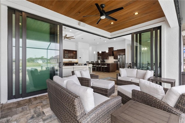 view of patio with outdoor lounge area and a ceiling fan