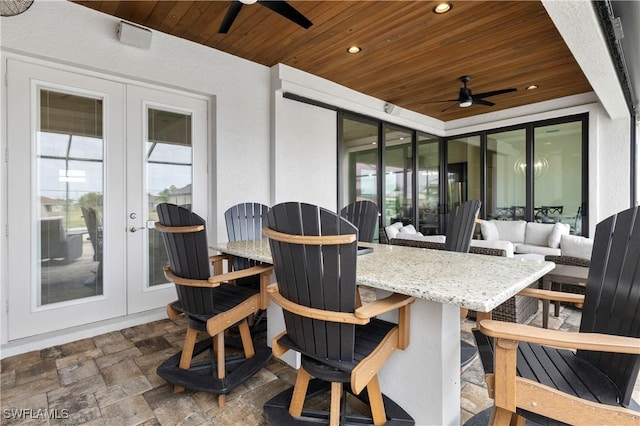 view of patio / terrace featuring outdoor dry bar, french doors, and a ceiling fan