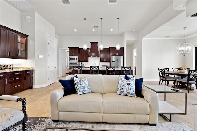 living area with light tile patterned floors, visible vents, baseboards, an inviting chandelier, and recessed lighting