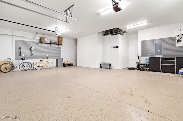 garage featuring electric panel and a garage door opener