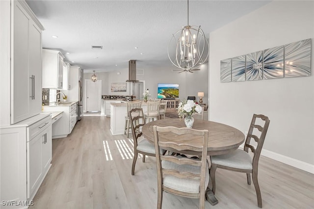 dining area with light wood finished floors, baseboards, visible vents, a chandelier, and recessed lighting