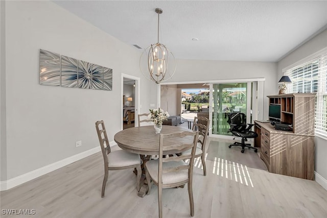 dining room with light wood finished floors, a notable chandelier, baseboards, and a wealth of natural light