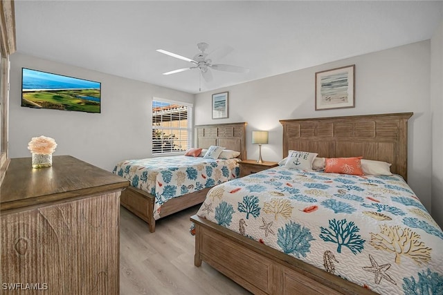 bedroom with light wood-type flooring and a ceiling fan