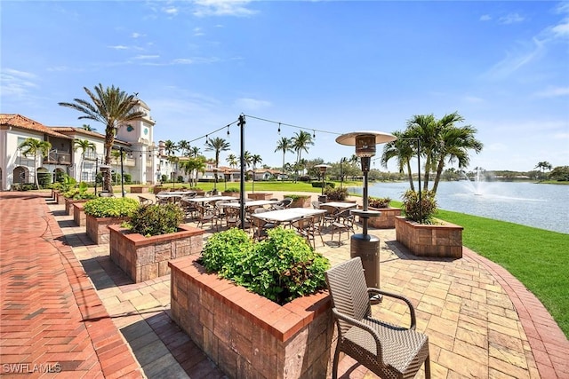 view of property's community featuring a water view and a patio