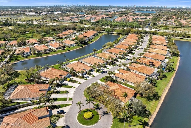 drone / aerial view with a water view and a residential view