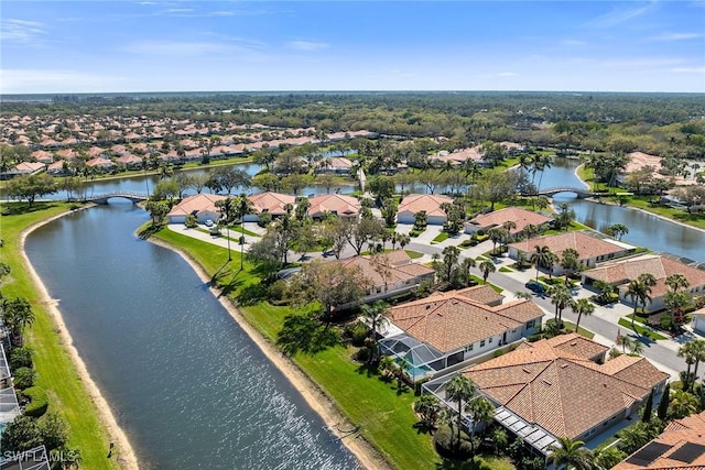 drone / aerial view featuring a water view and a residential view