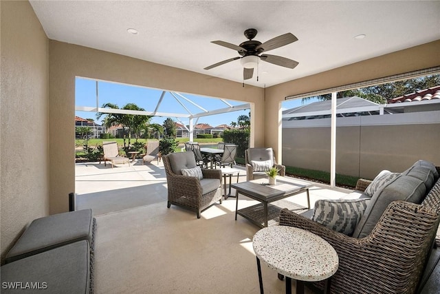 sunroom / solarium featuring a ceiling fan