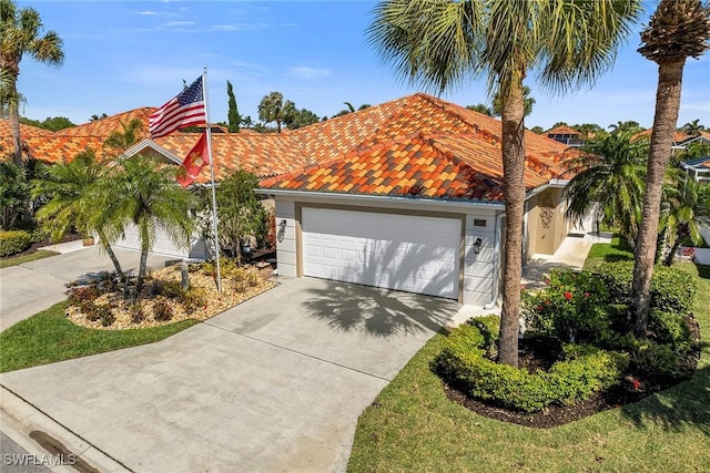 view of front of property featuring a garage, concrete driveway, and a tiled roof