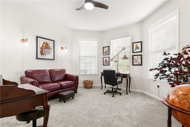 office area with carpet, baseboards, and a ceiling fan