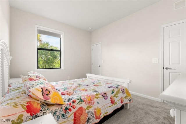 carpeted bedroom with visible vents and baseboards