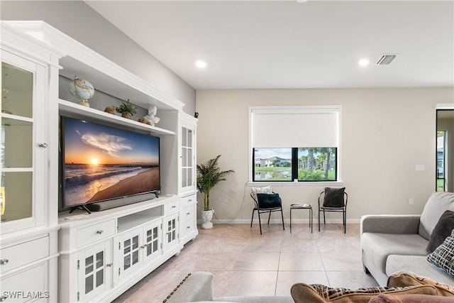 living area featuring recessed lighting, visible vents, baseboards, and light tile patterned flooring