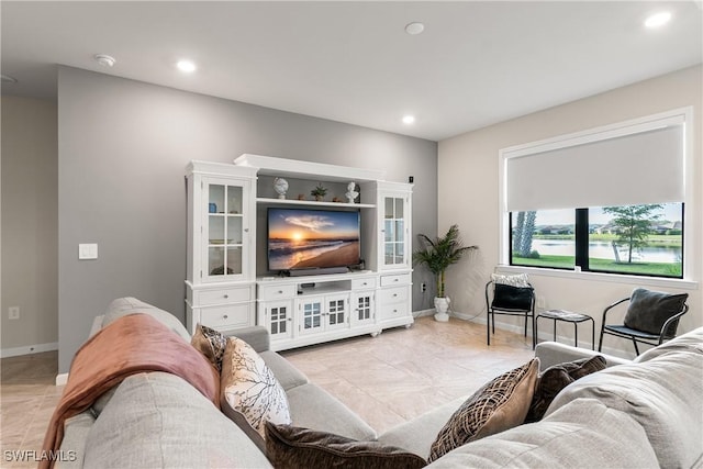 living area with baseboards and recessed lighting