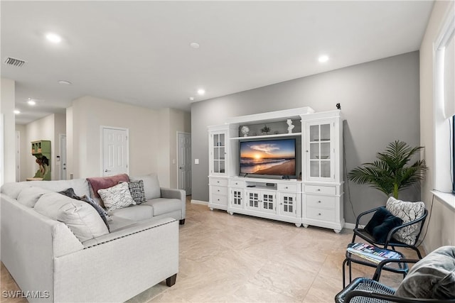 living area with baseboards, visible vents, and recessed lighting