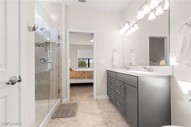 ensuite bathroom featuring double vanity, visible vents, ensuite bathroom, a shower stall, and a sink