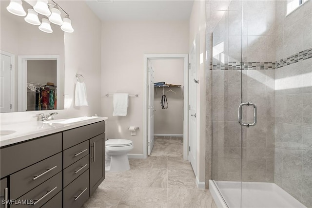bathroom with toilet, a stall shower, vanity, a chandelier, and baseboards
