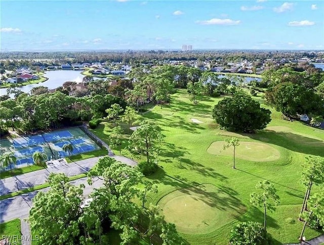 birds eye view of property featuring golf course view and a water view