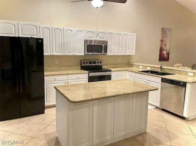 kitchen featuring light tile patterned floors, appliances with stainless steel finishes, white cabinets, a sink, and a peninsula