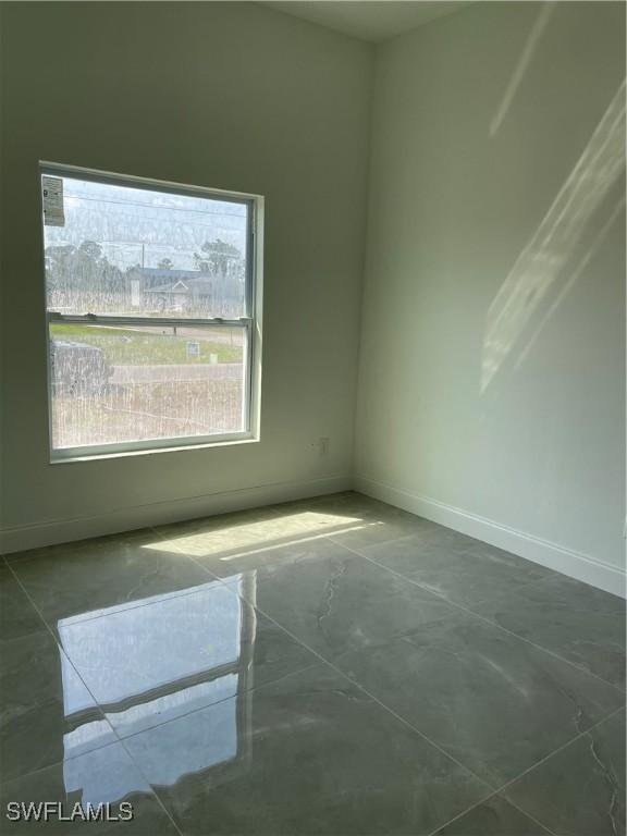 empty room featuring baseboards