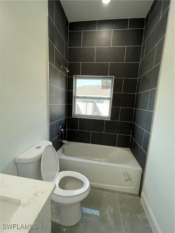 full bath featuring vanity, baseboards, shower / bath combination, toilet, and marble finish floor