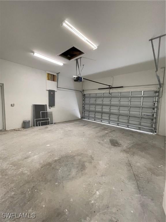 garage featuring electric panel and a garage door opener