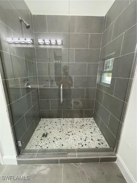 full bath with a shower stall