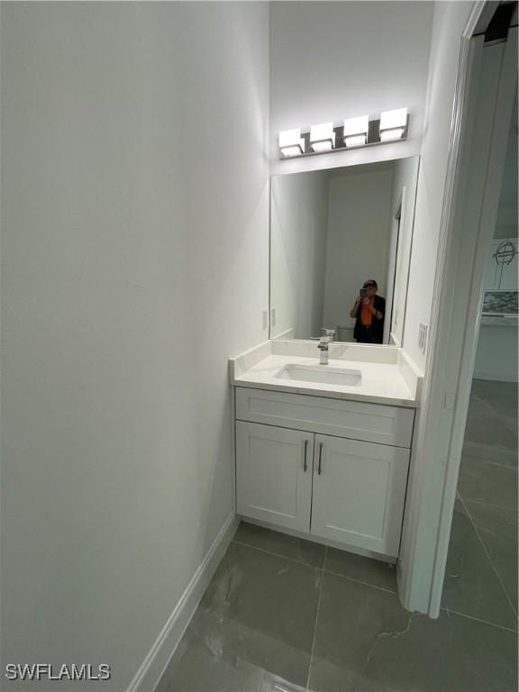 bathroom with baseboards and vanity