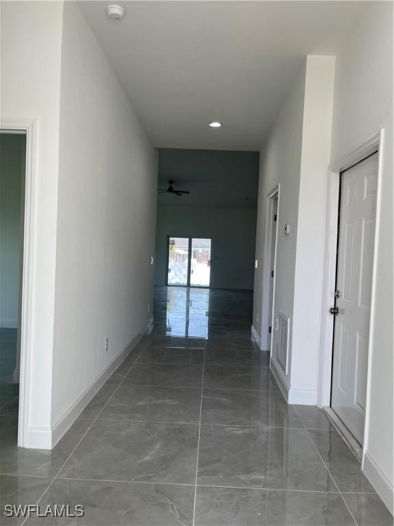 corridor featuring visible vents and baseboards