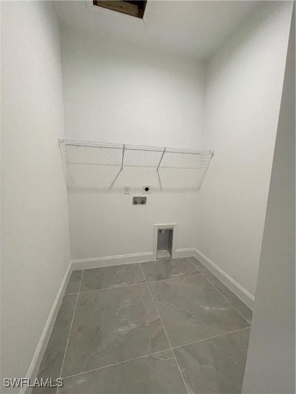 laundry area with laundry area, baseboards, and electric dryer hookup