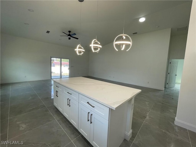 kitchen with white cabinets, visible vents, open floor plan, and a center island