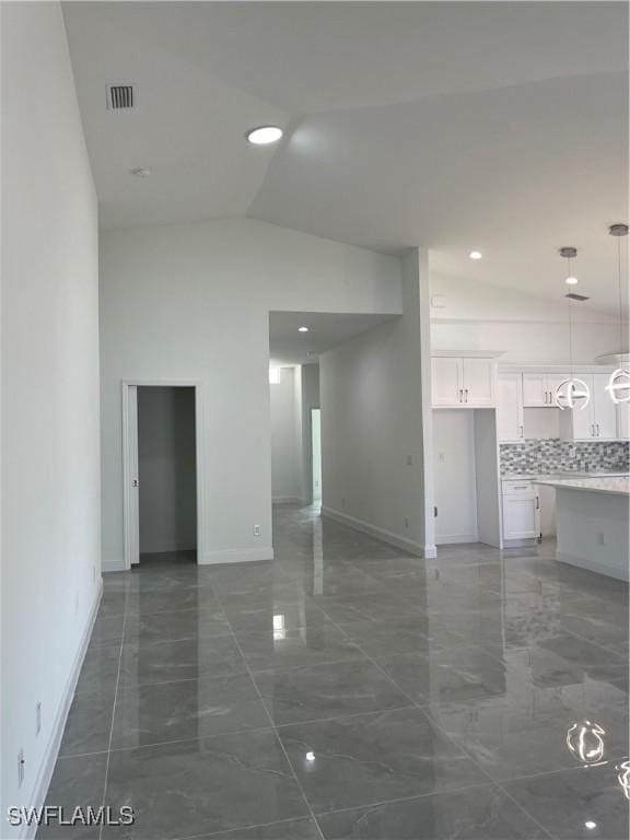 unfurnished room featuring baseboards, visible vents, recessed lighting, vaulted ceiling, and marble finish floor