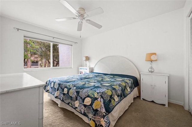 bedroom with baseboards, carpet, a ceiling fan, and a closet