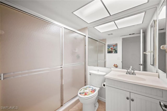 bathroom with toilet, a stall shower, tile patterned flooring, and vanity