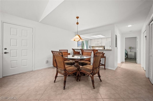 dining area with baseboards and light tile patterned floors