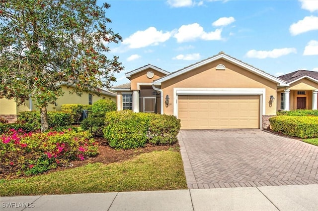 ranch-style house with a garage, decorative driveway, and stucco siding