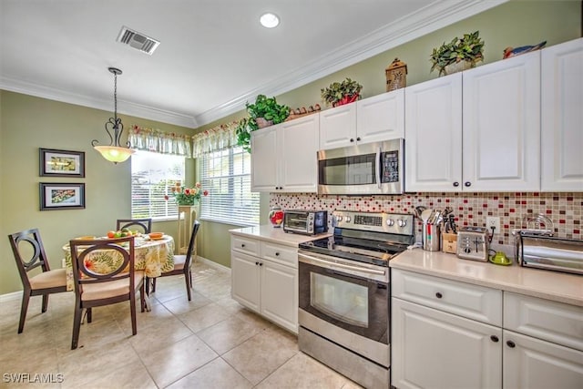 kitchen with stainless steel appliances, ornamental molding, backsplash, and light countertops