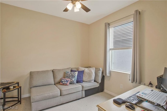 living room with light colored carpet, a ceiling fan, and baseboards