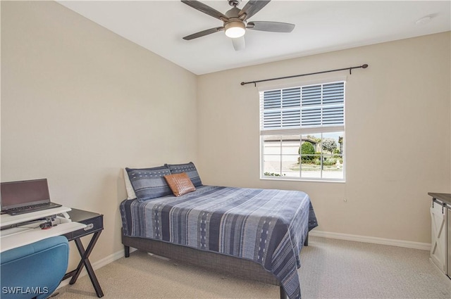 bedroom with a ceiling fan, baseboards, and carpet floors