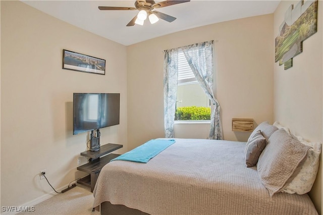 carpeted bedroom featuring baseboards and ceiling fan